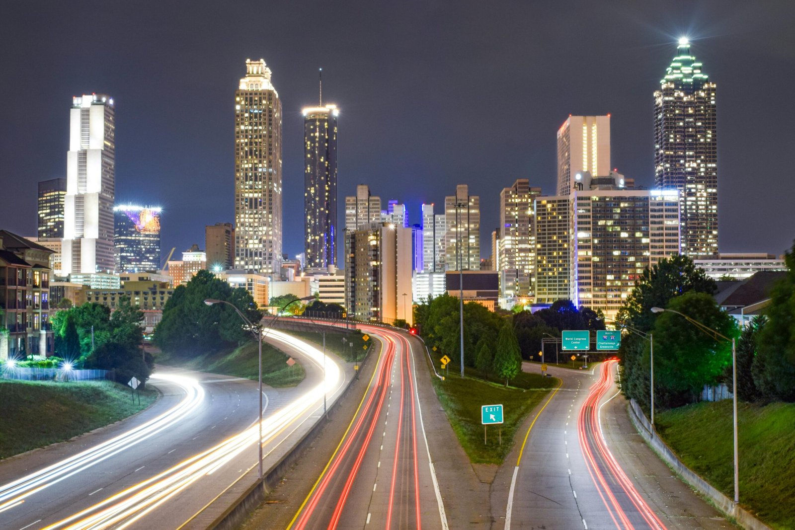Vibrant night view of Atlanta, Georgia city skyline with light trails highlighting urban motion.